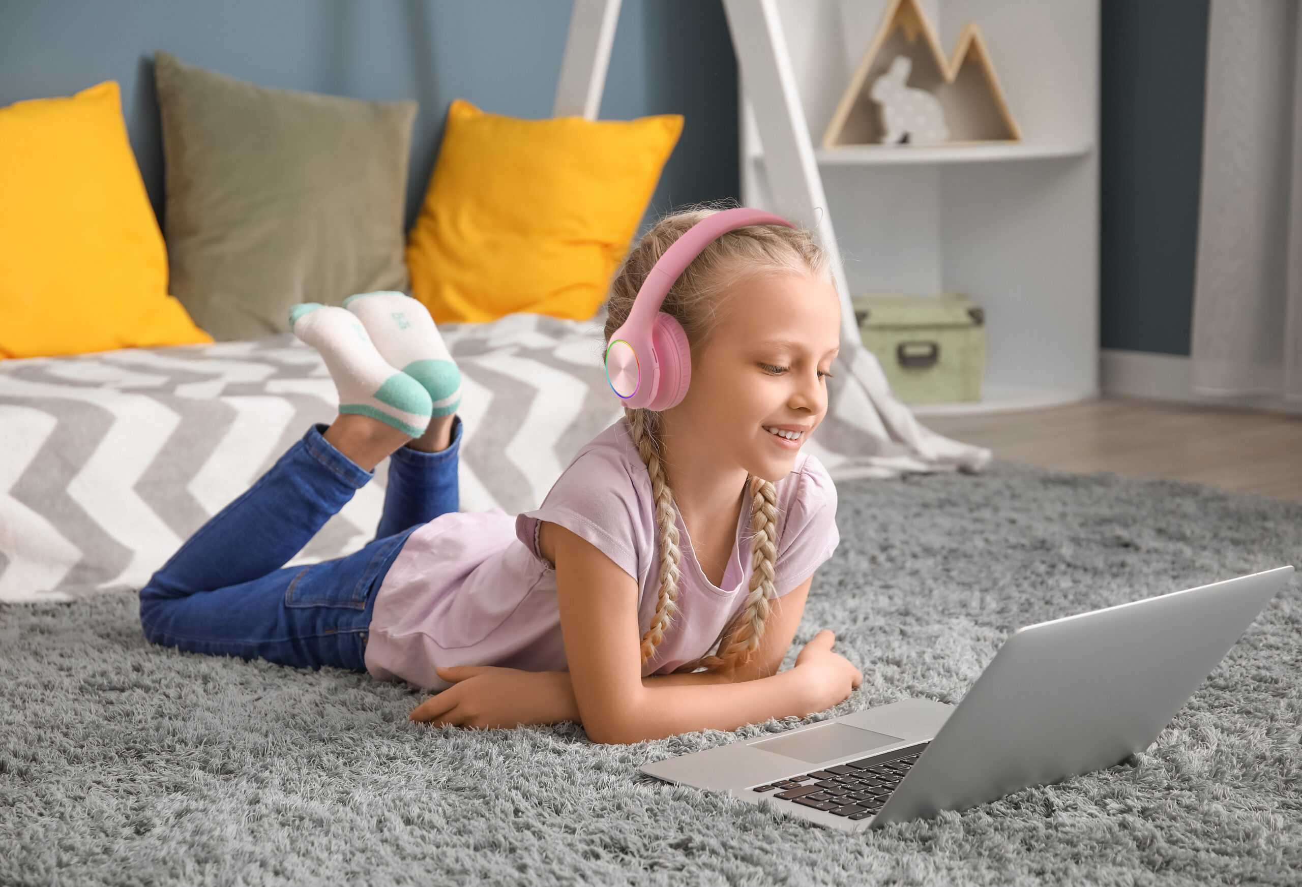 Cute little girl with laptop at home. Concept of online education