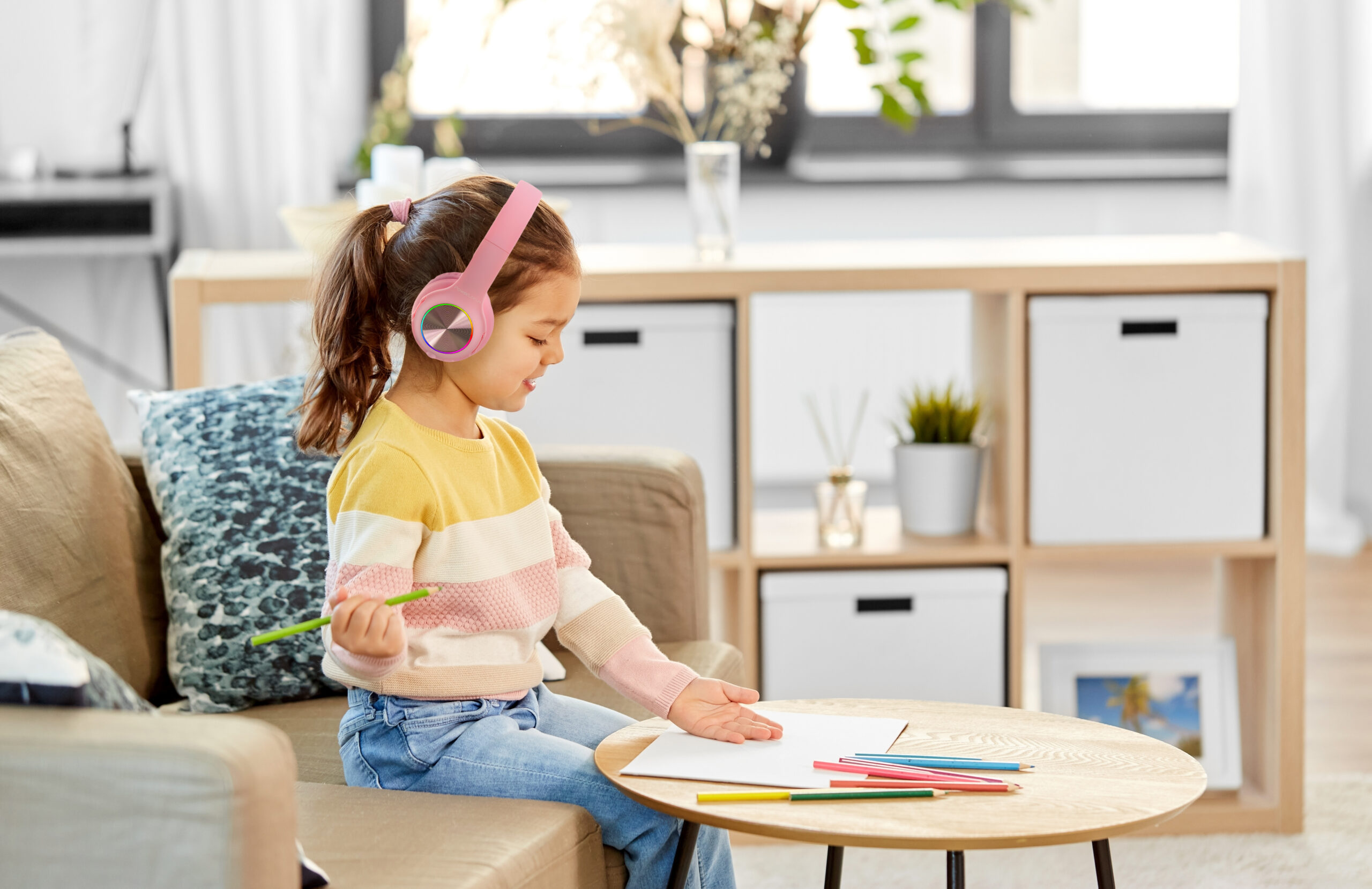 childhood, creativity and art concept - happy smiling little girl drawing with coloring pencils at home